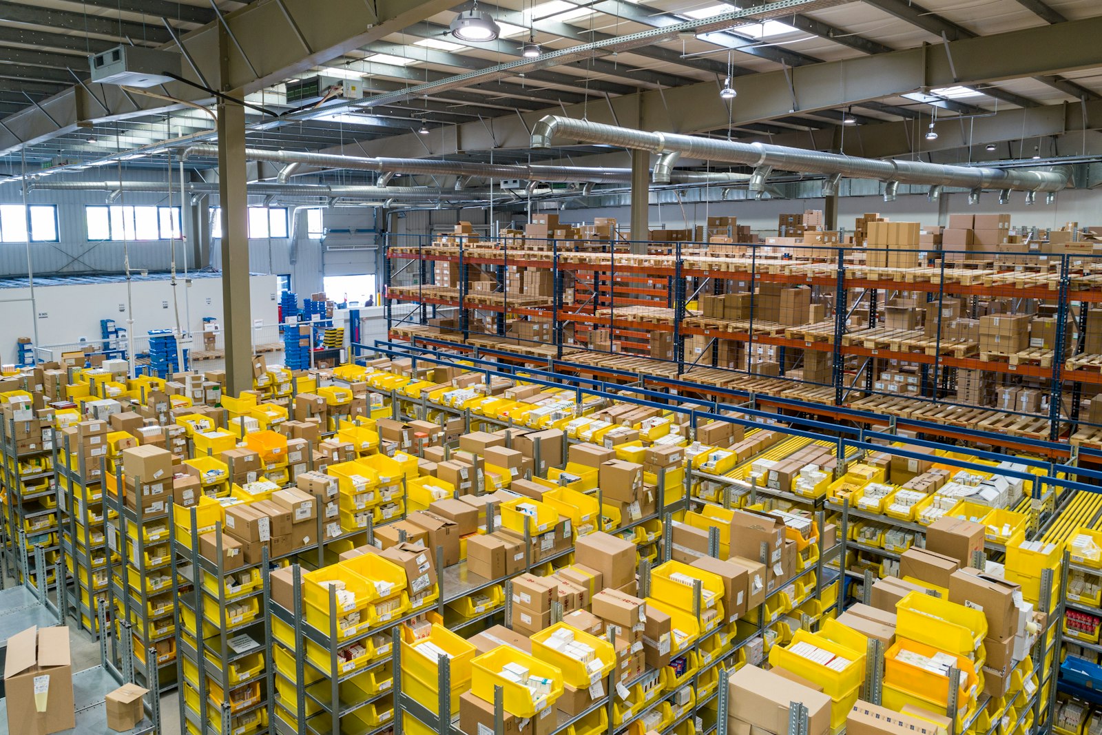 Distribution warehouse interior with pallet racking and packed shelves